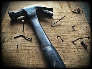 Construction Hammer and Nails lying on the floor. 